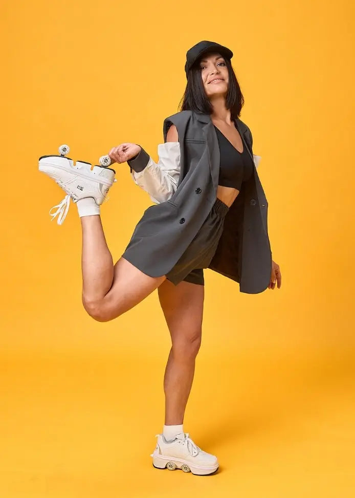 Confident woman in stylish Liekick transformable roller shoes, posing against a bold yellow background, showcasing versatility and modern fashion.
